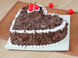 Side View of Heart Shaped Black Forest Cake with Choco Flakes Toppings