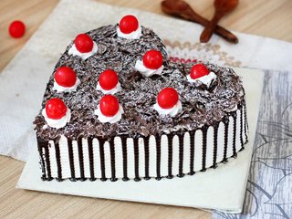 Side View of Heart Shaped Black Forest Cake with Cherry Toppings