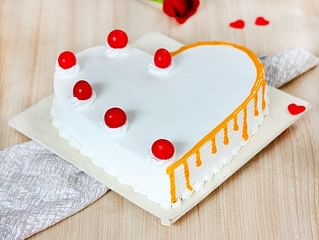 Heart Shaped Vanilla Flavored Cake with Cherries on Top Heart Shaped Vanilla Flavored Cake with Cherries on Top